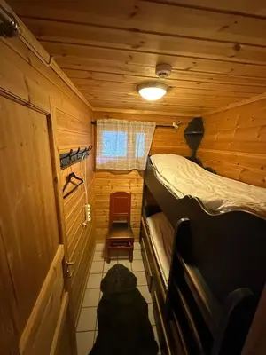 a bedroom with a bed in a wooden cabin at Fjellleilighet med drømmeutsikt in Oppdal