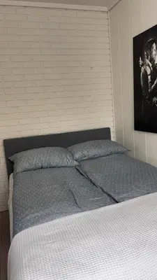 a bed in a bedroom with a picture on the wall at Hyggehuset in Bergen