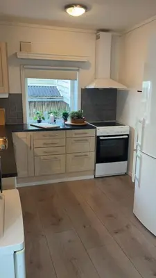 a kitchen with a white stove and a white refrigerator at Hyggehuset in Bergen