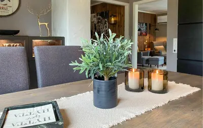 a table with candles and a potted plant on it at Stunning Home In Bjorli With Wifi in Bjorli