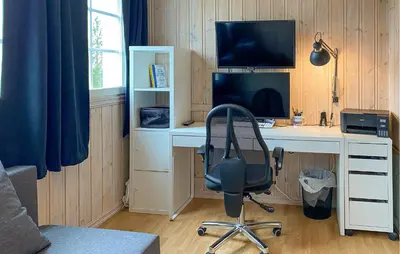 a desk with a computer and a chair in a room at Stunning Home In Bjorli With Wifi in Bjorli
