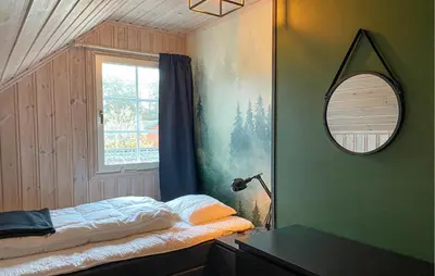 a bedroom with a bed and a mirror and a window at Stunning Home In Bjorli With Wifi in Bjorli