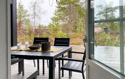 a table and chairs on a porch with a view at Stunning Home In Bjorli With Wifi in Bjorli