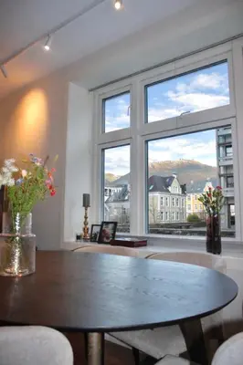a dining room with a table and a large window at Central apartment in Bergen