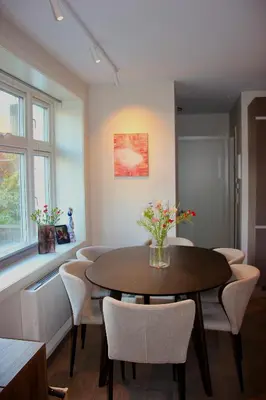 a dining room with a table and chairs at Central apartment in Bergen