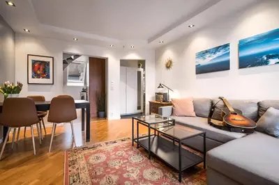 a living room with a couch and a table at Bright Top-Floor Apartment with Sea View in Bergen