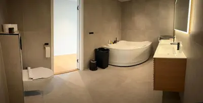 a bathroom with two sinks and a toilet at Husafjellet in Ålesund