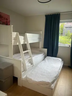 two bunk beds in a room with a window at Husafjellet in Ålesund
