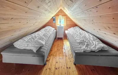 a room with two beds in a tiny house at Nice Home In Manger With House Sea View in Manger