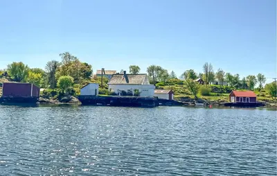 a house on the shore of a body of water at Nice Home In Manger With House Sea View in Manger