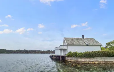 a building sitting on the side of a body of water at Nice Home In Manger With House Sea View in Manger