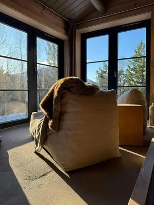 a couch in a living room with large windows at Timber Cabin By The Ski Slopes In Oppdal in Oppdal