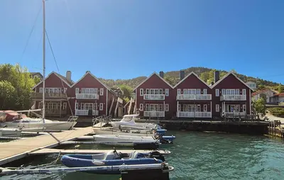 a group of boats docked in front of a building at Nice Apartment In Auklandshamn in Vestvik