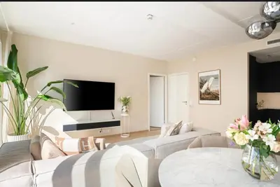 a living room with two couches and a flat screen tv at Wow in Bergen