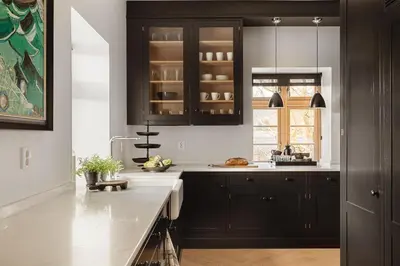 a kitchen with black cabinets and white counter tops at Exclusive Villa - Scandinavian Luxury At Its Best in Bergen