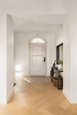 a white room with a white door and a wooden floor at Exclusive Villa - Scandinavian Luxury At Its Best in Bergen