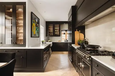a kitchen with black cabinets and a stove at Exclusive Villa - Scandinavian Luxury At Its Best in Bergen