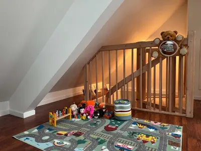 a rug with toys on the floor next to a staircase at Heimby Homes - Four Bedroom Family Penthouse in Bergen