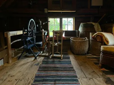 a room with wooden floors and a window and furniture at Historic Farmhouse In Scenic Isfjorden in Isfjorden