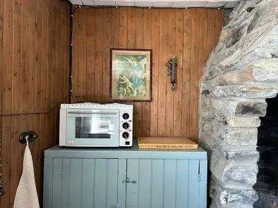 a microwave sitting on top of a cabinet at Historic Farmhouse In Scenic Isfjorden in Isfjorden