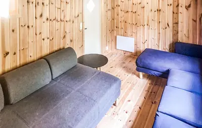 a living room with a couch and a chair at 4 Bedroom Stunning Home In Tynset in Tynset