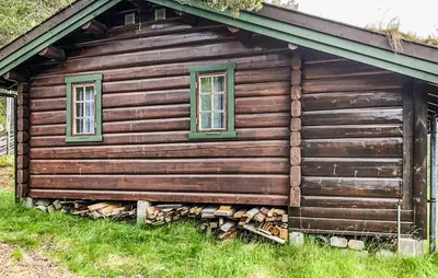 a log cabin with two windows on the side of it at 4 Bedroom Stunning Home In Tynset in Tynset