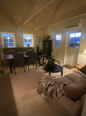 a living room with a couch and a table at Ingeborgstova in Lii