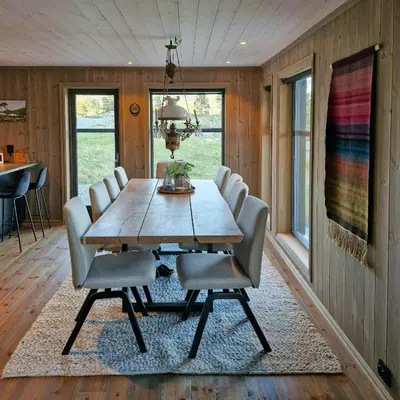 a dining room with a wooden table and chairs at Mountain Cabin With Sauna In Sunnmørsalpane in Brunstad