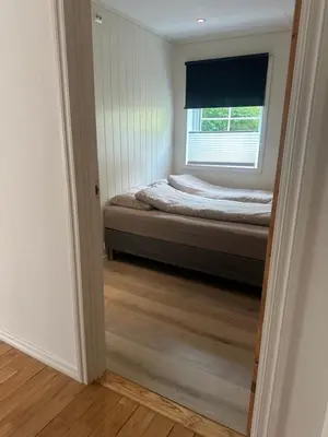 a bedroom with a bed and a window at Fjordpust og fjellsteg - Stryn in Stryn
