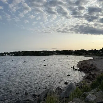 two people standing in the water on a beach at 047 Farmhouse - Nevlunghavn in Lii