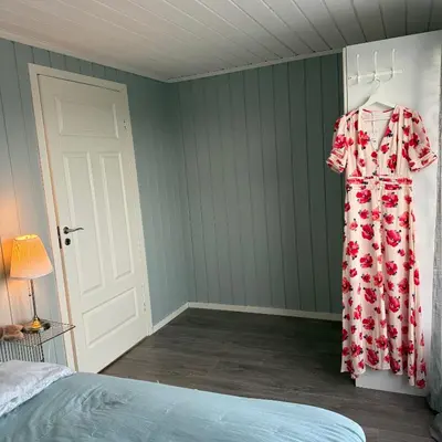 a dress hanging on a wall in a bedroom at 047 Farmhouse - Nevlunghavn in Lii