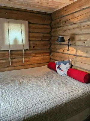 a bedroom with a bed in a log cabin at Timber Cabin With Mountain Views In Synnfjellet in Skartlia