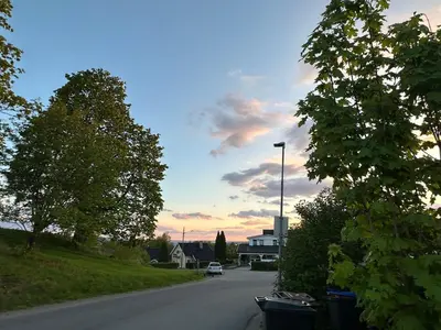 a street with a car driving down a road at Scandinavian Style Ridabu Hamar in Hamar