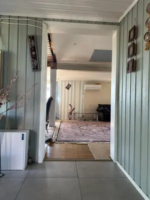a hallway leading to a living room with a rug at Scandinavian Style Ridabu Hamar in Hamar