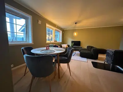a living room with a table and chairs at Leilighet nært sentrum in Stryn
