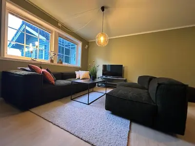 a living room with two couches and a television at Leilighet nært sentrum in Stryn