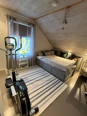 a small room with a bed and a treadmill at Summer villa with heated pool 50 min from Bergen