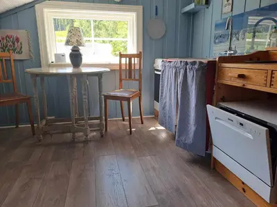 a kitchen with a table and a table and a window at xxx in Ryfoss