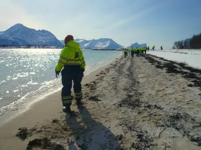 a group of firefighters walking on the beach at Posthuset Expedition Lodge in Lii