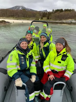 a group of people sitting in a boat on the water at Posthuset Expedition Lodge in Lii