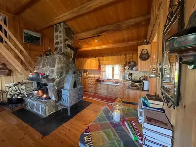 a kitchen with a stone fireplace in a cabin at Thorpeset cabin by Norgesbooking - cabin with amazing view in Uvdal