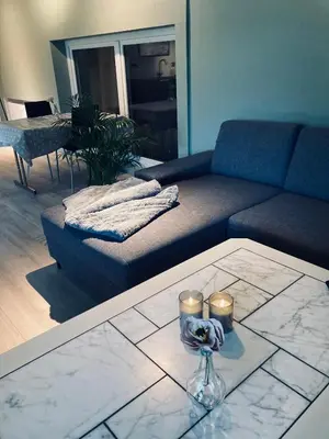 a living room with a couch and candles on a table at Petersstova in Ålesund
