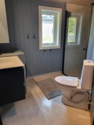 a bathroom with a toilet and a sink and a window at Koselig liten fjellhytte i flott turterreng både sommer og vinter in Hovda