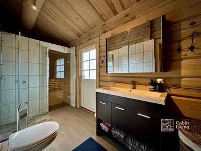 a bathroom with a sink and a toilet at Stylish log cabin in Hafjell with view & sauna in Hafjell