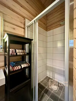 a sauna with a glass shower and a wooden ceiling at Stylish log cabin in Hafjell with view & sauna in Hafjell