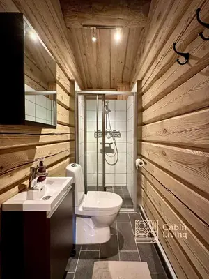 a bathroom with a toilet and a sink at Stylish log cabin in Hafjell with view & sauna in Hafjell