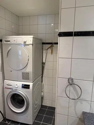 a washer and dryer in a small bathroom at Modern Apartment in City Center with Parking Garage in Ålesund