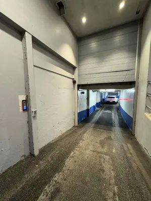 an empty parking garage with a car in a tunnel at Modern Apartment in City Center with Parking Garage in Ålesund