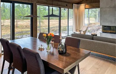 a dining room with a table and a couch at 4 Bedroom Stunning Home In Eggedal in Eggedal
