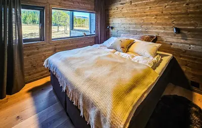 a bed in a room with a wooden wall at 4 Bedroom Stunning Home In Eggedal in Eggedal